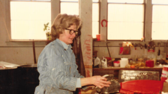A vintage photo of Milly Zantow sorting recyclables.