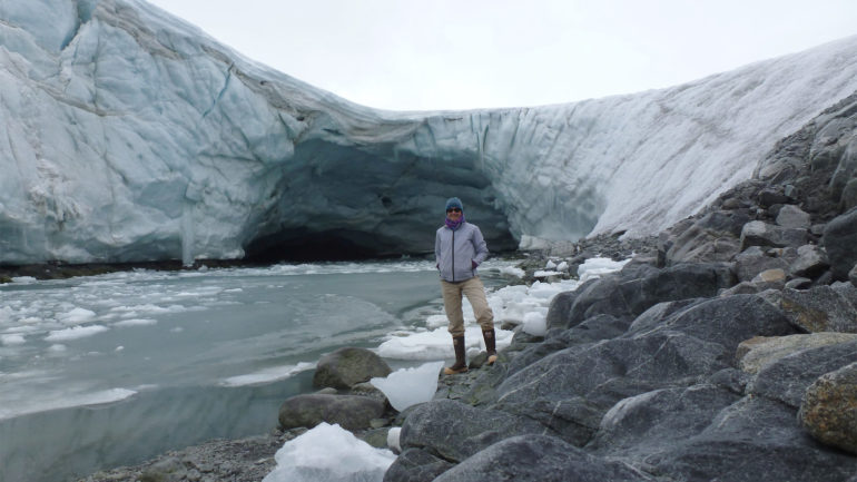 Woman standing in front of glacier Woman standing in front of glacier