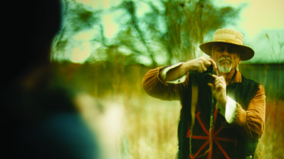 A man holds a camera up to take a picture.