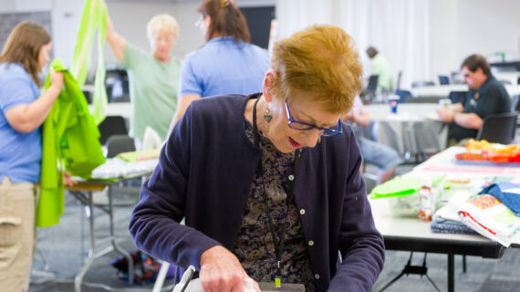 Women ironing fabric for a quilt project