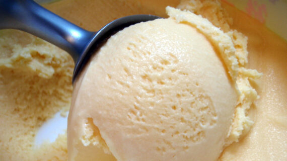 Spoon scooping vanilla ice cream