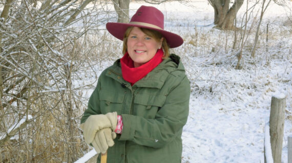 Inga Witscher smiles, posing in a snowy landscape.