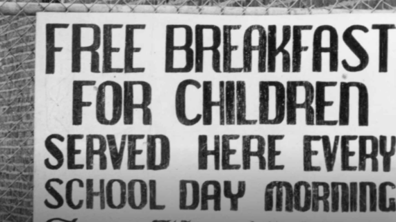 Black and white signage from the era of the Black Panthers Free School Lunch program reads: 