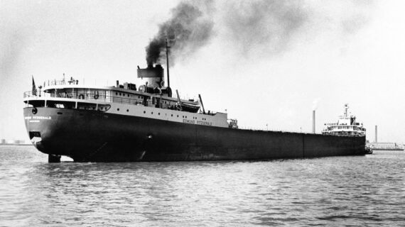 A grayscale photo shows a lake freighter with the name