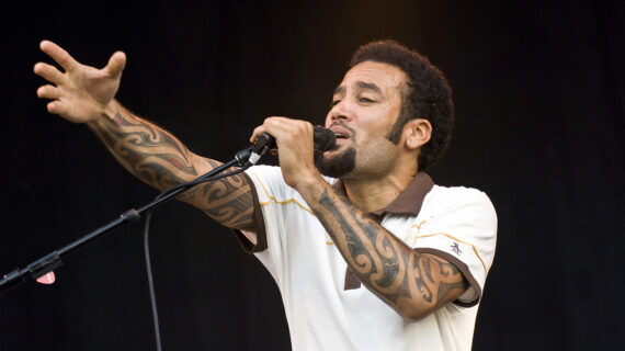 A man holding a microphone performs on stage.