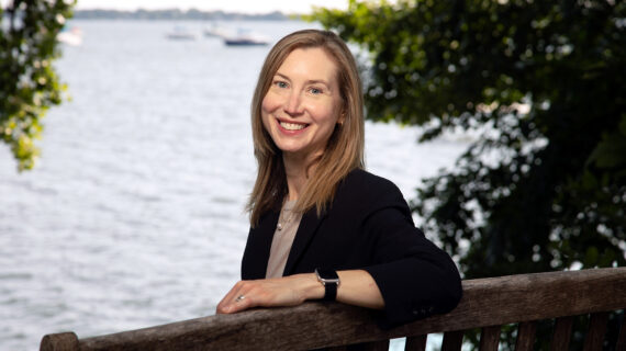Sarah Ashworth sits on a bench overlooking a lake.